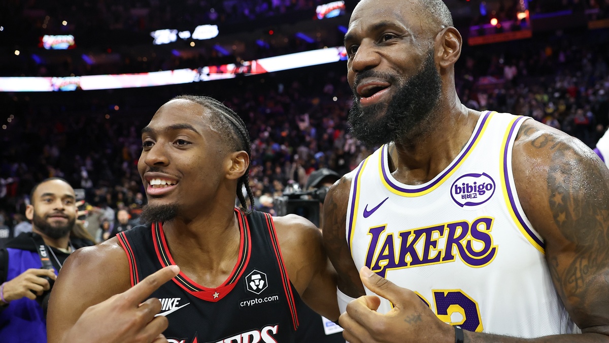 Los Angeles Lakers forward LeBron James #23 meets with Philadelphia 76ers guard Tyrese Maxey after the game at Xfinity Mobile Arena.
