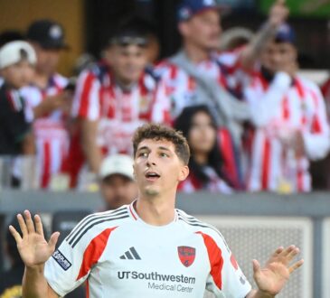 FC Dallas forward Logan Farrington raises both hands to the crowd after scoring against Guadalajara