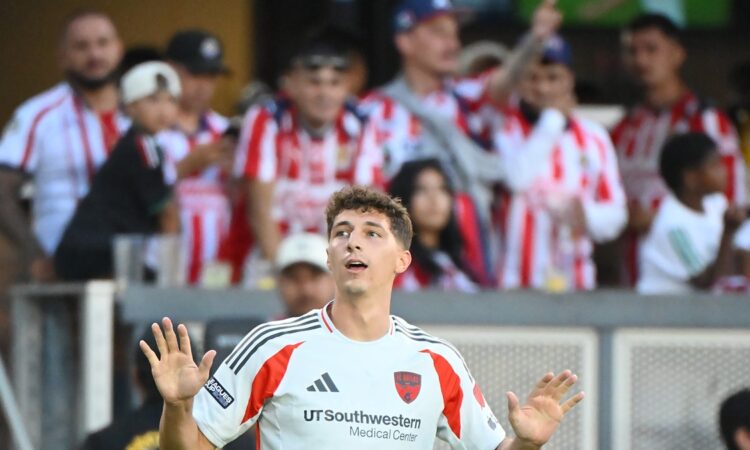 FC Dallas forward Logan Farrington raises both hands to the crowd after scoring against Guadalajara