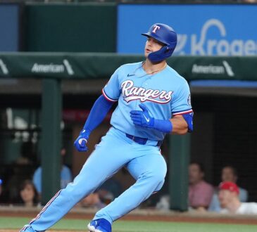 Texas Rangers designated hitter Logan O'Hoppe runs up the first base line after a single at Globe Life Field.