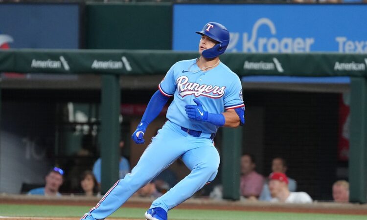 Texas Rangers designated hitter Logan O'Hoppe runs up the first base line after a single at Globe Life Field.