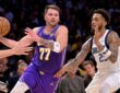 Los Angeles Lakers guard Luka Dončić drives to the basket as Dallas Mavericks forward P.J. Washington defends.