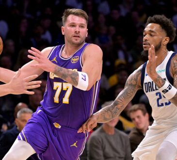 Los Angeles Lakers guard Luka Dončić drives to the basket as Dallas Mavericks forward P.J. Washington defends.