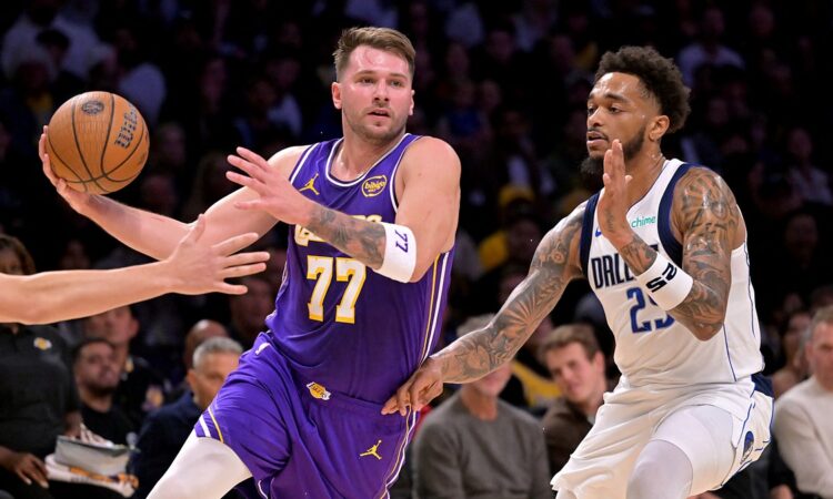 Los Angeles Lakers guard Luka Dončić drives to the basket as Dallas Mavericks forward P.J. Washington defends.