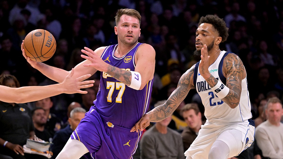 Los Angeles Lakers guard Luka Dončić drives to the basket as Dallas Mavericks forward P.J. Washington defends.