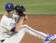 Texas Rangers pitcher MacKenzie Gore lifts his leg into the windup with his glove raised on the mound.