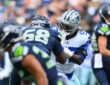 Dallas Cowboys linebacker Malachi Lawrence fights through the block of Seattle Seahawks offensive lineman Bryce Hart.