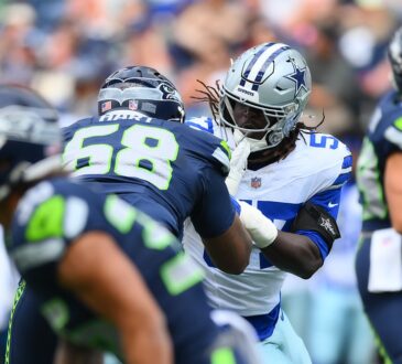 Dallas Cowboys linebacker Malachi Lawrence fights through the block of Seattle Seahawks offensive lineman Bryce Hart.