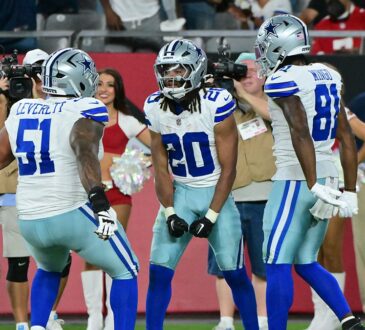 Dallas Cowboys running back Malik Davis celebrates a touchdown with teammates Nick Leverett and Jonathan Mingo.