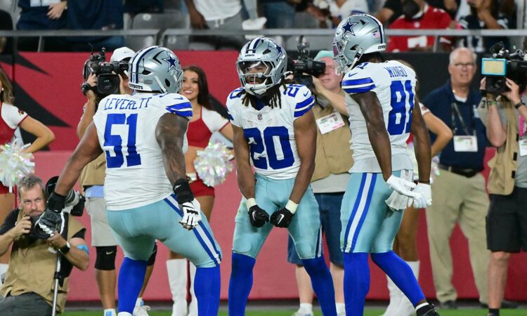 Dallas Cowboys running back Malik Davis celebrates a touchdown with teammates Nick Leverett and Jonathan Mingo.