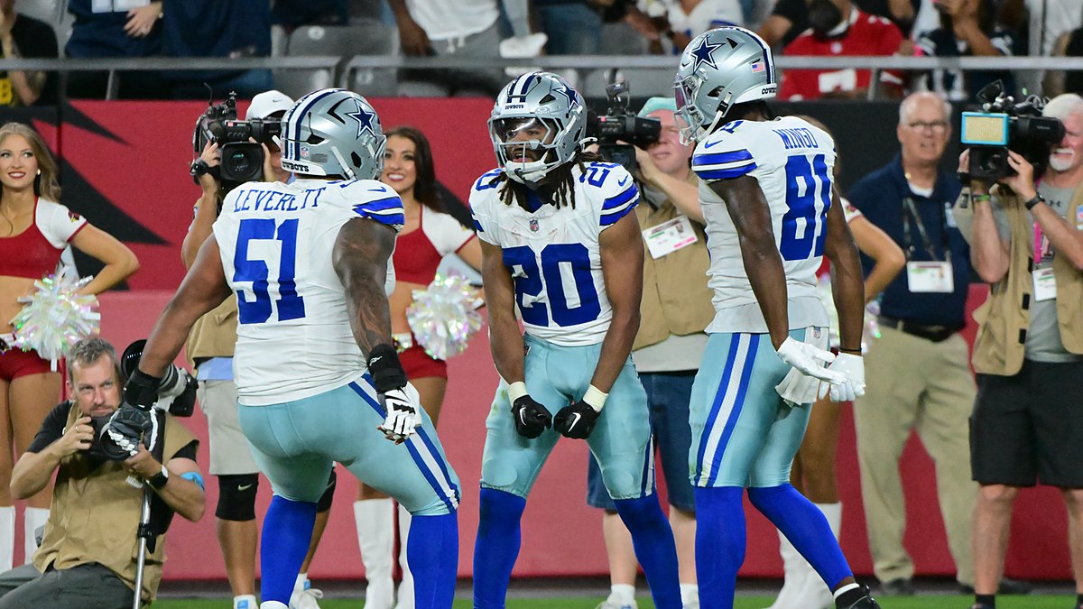 Dallas Cowboys running back Malik Davis celebrates a touchdown with teammates Nick Leverett and Jonathan Mingo.