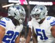 Dallas Cowboys running back Jaydon Blue hurdles an Arizona Cardinals defender on a first-half carry.
