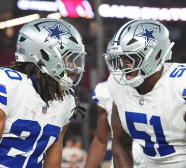Dallas Cowboys running back Jaydon Blue hurdles an Arizona Cardinals defender on a first-half carry.