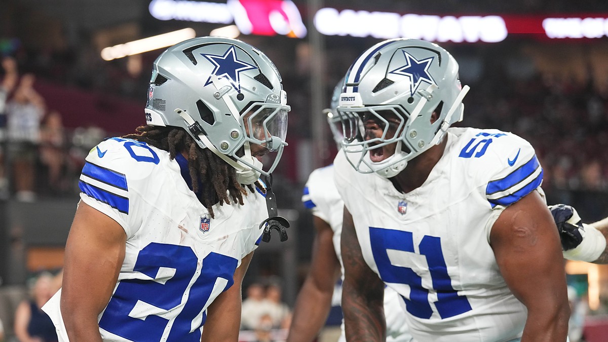 Dallas Cowboys running back Jaydon Blue hurdles an Arizona Cardinals defender on a first-half carry.