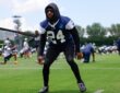 Dallas Cowboys safety Malik Hooker pulls against a resistance cord in a crouched stance during a practice drill.
