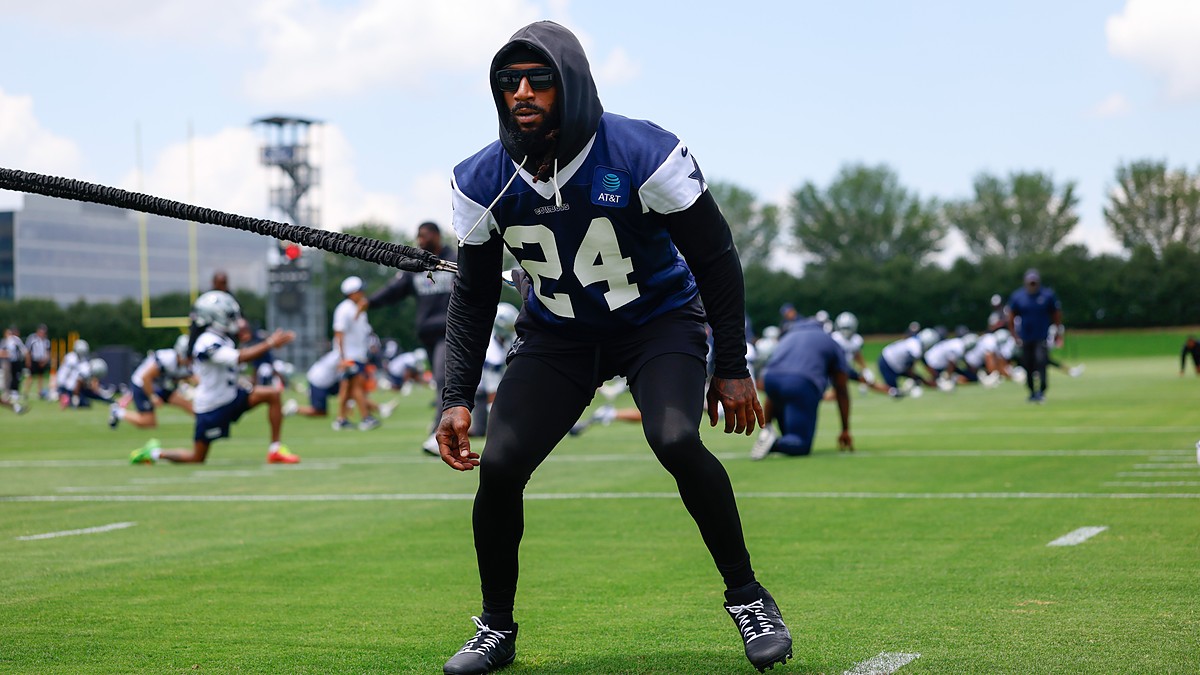 Dallas Cowboys safety Malik Hooker pulls against a resistance cord in a crouched stance during a practice drill.