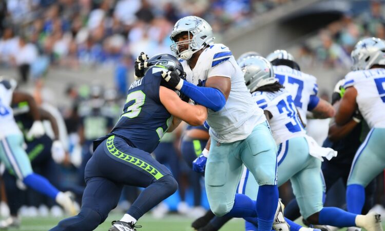 Dallas Cowboys offensive tackle Marcellus Johnson locks up Seattle Seahawks linebacker Aidan Hubbard at the line.