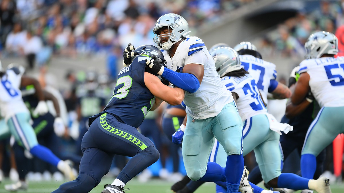 Dallas Cowboys offensive tackle Marcellus Johnson locks up Seattle Seahawks linebacker Aidan Hubbard at the line.