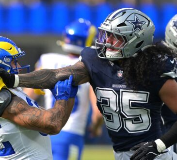 Dallas Cowboys linebacker Marist Liufau grabs Rams running back Cody Schrader by the shoulder after a play.