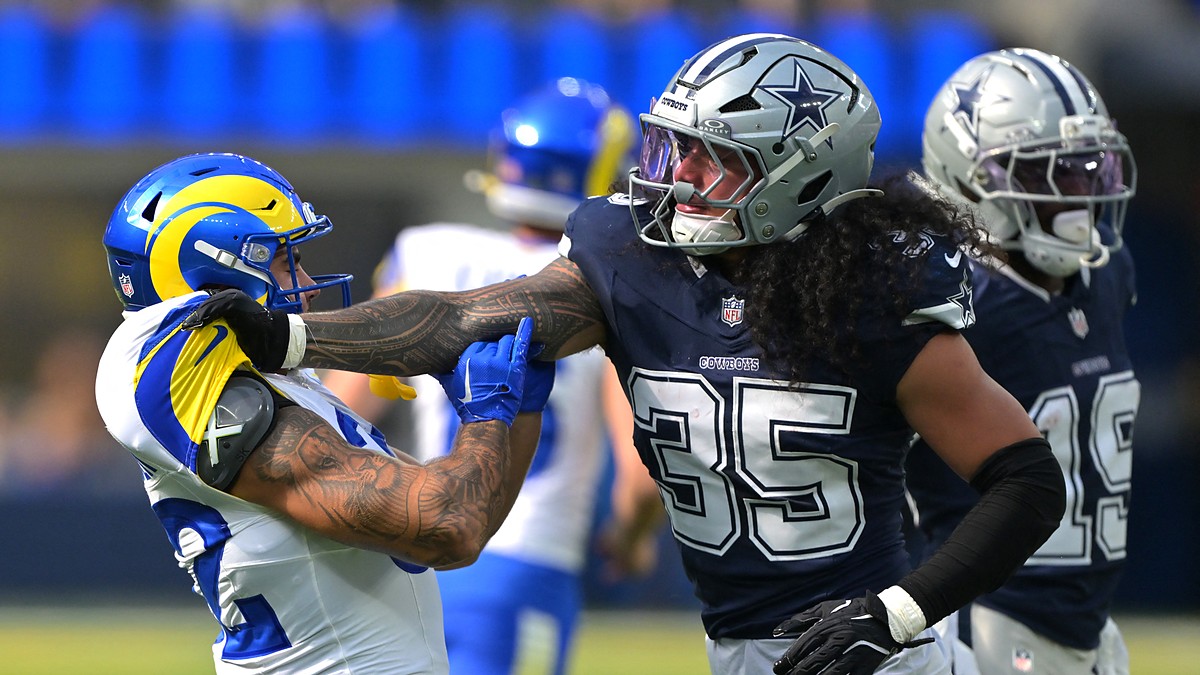 Dallas Cowboys linebacker Marist Liufau grabs Rams running back Cody Schrader by the shoulder after a play.