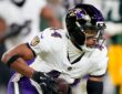 Baltimore Ravens cornerback Marlon Humphrey secures an interception and turns upfield against the Green Bay Packers.