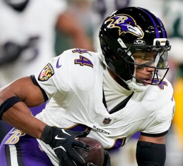 Baltimore Ravens cornerback Marlon Humphrey secures an interception and turns upfield against the Green Bay Packers.