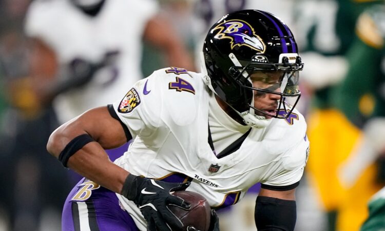 Baltimore Ravens cornerback Marlon Humphrey secures an interception and turns upfield against the Green Bay Packers.