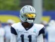 Dallas Cowboys wide receiver Marquez Valdes-Scantling stands in a gold visor during joint practice with the Rams.