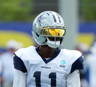 Dallas Cowboys wide receiver Marquez Valdes-Scantling stands in a gold visor during joint practice with the Rams.