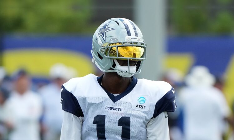 Dallas Cowboys wide receiver Marquez Valdes-Scantling stands in a gold visor during joint practice with the Rams.
