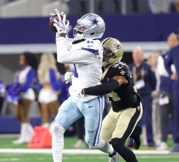 Dallas Cowboys wide receiver Marquez Valdes-Scantling hauls in a pass with a New Orleans Saints defender trailing.