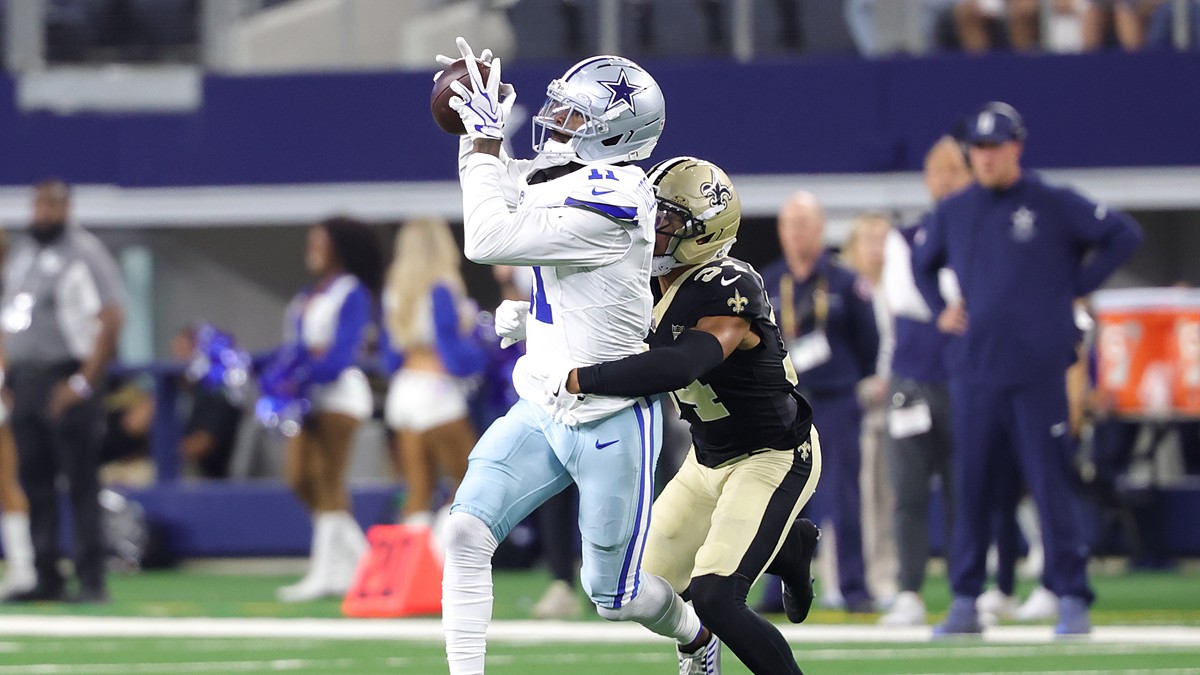 Dallas Cowboys wide receiver Marquez Valdes-Scantling hauls in a pass with a New Orleans Saints defender trailing.