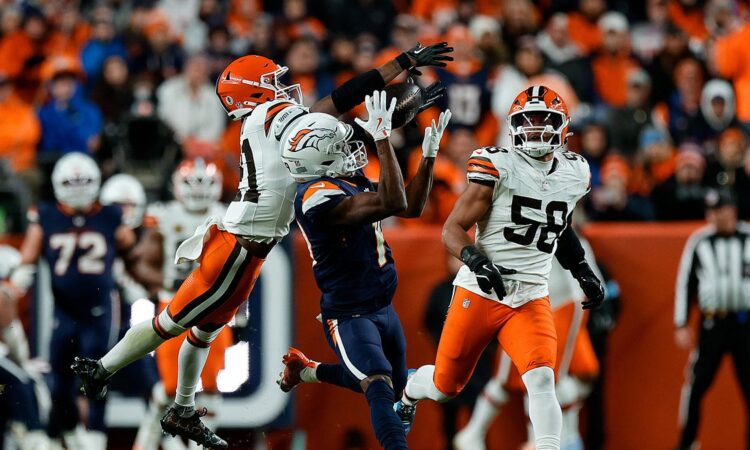 Denver Broncos wide receiver Marvin Mims Jr. reaches back for a catch as Cleveland Browns cornerback Denzel Ward defends.