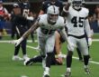 Las Vegas Raiders defensive end Maxx Crosby spreads his arms and shouts after making a tackle against the Chargers.