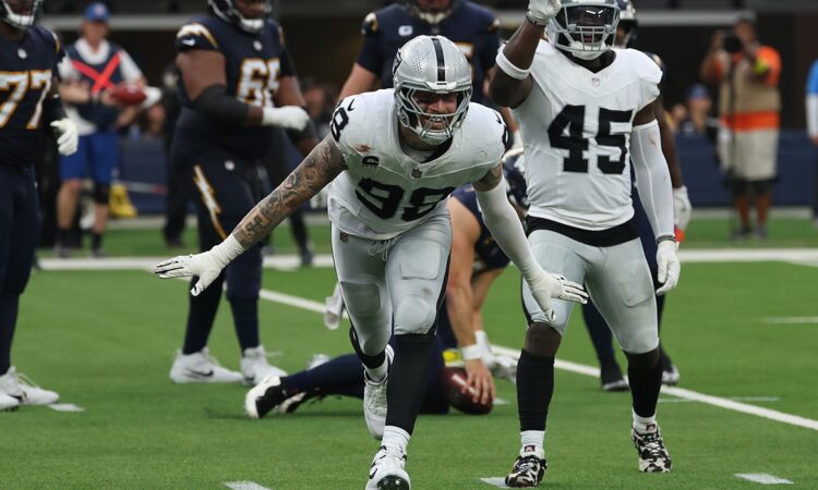 Las Vegas Raiders defensive end Maxx Crosby spreads his arms and shouts after making a tackle against the Chargers.