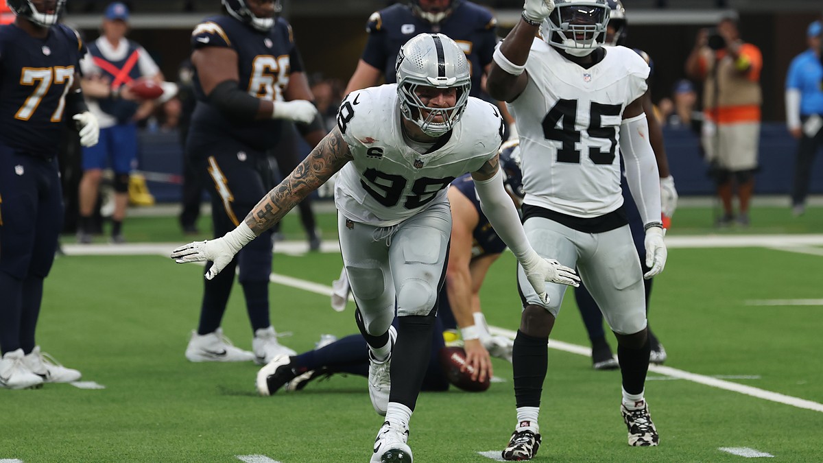 Las Vegas Raiders defensive end Maxx Crosby spreads his arms and shouts after making a tackle against the Chargers.
