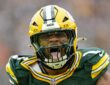 Green Bay Packers defensive end Micah Parsons roars in celebration after a sack while wearing his No. 1 jersey.