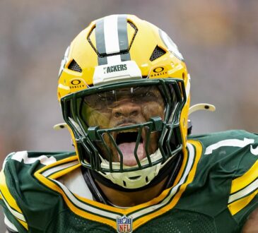 Green Bay Packers defensive end Micah Parsons roars in celebration after a sack while wearing his No. 1 jersey.