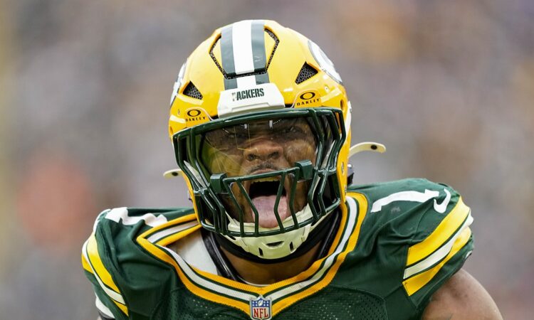 Green Bay Packers defensive end Micah Parsons roars in celebration after a sack while wearing his No. 1 jersey.