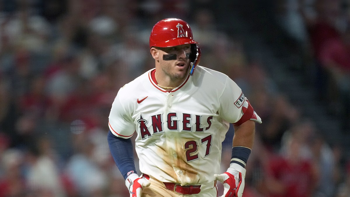 Los Angeles Angels center fielder Mike Trout jogs up the line in a dirt-streaked jersey after a base hit.