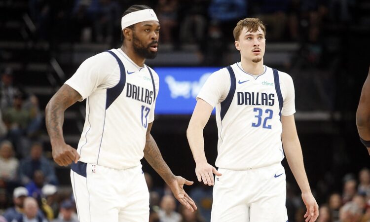 Dallas Mavericks forwards Naji Marshall and Cooper Flagg slap hands as they walk upcourt against Memphis.