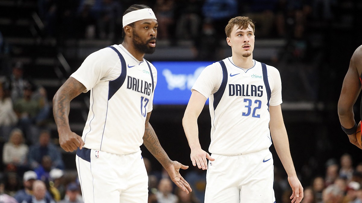 Dallas Mavericks forwards Naji Marshall and Cooper Flagg slap hands as they walk upcourt against Memphis.