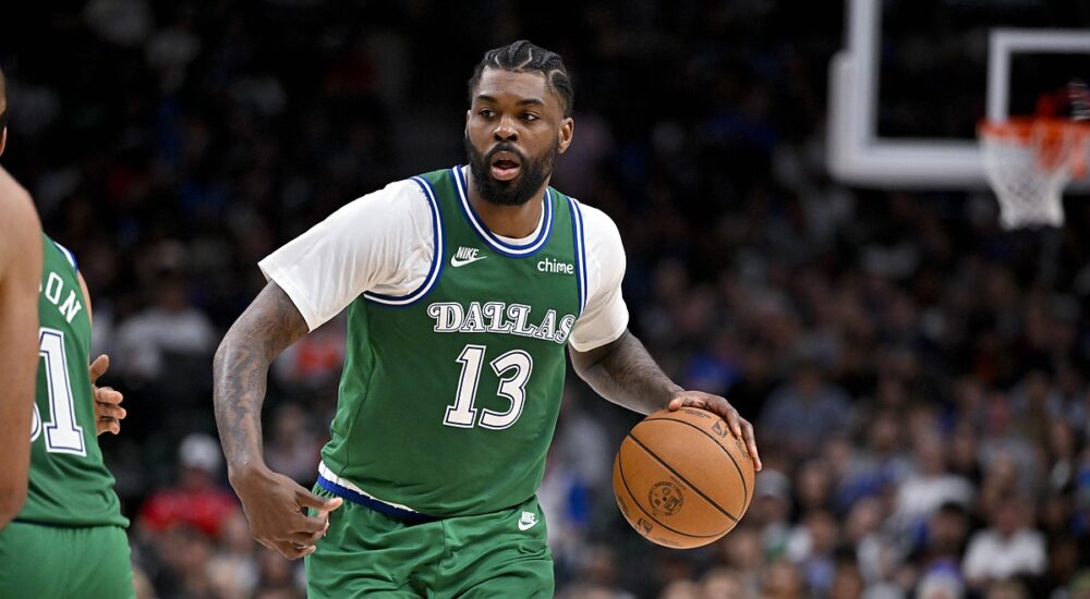 Dallas Mavericks forward Naji Marshall dribbles up the floor as a Los Angeles Clippers defender tracks the play.
