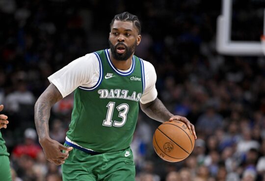 Dallas Mavericks forward Naji Marshall dribbles up the floor as a Los Angeles Clippers defender tracks the play.