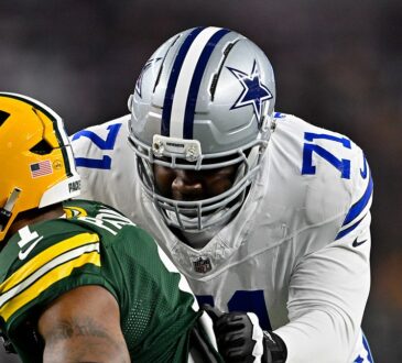 Dallas Cowboys offensive tackle Nathan Thomas locks up with Green Bay Packers defensive end Micah Parsons in pass protection.