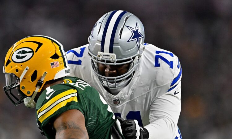 Dallas Cowboys offensive tackle Nathan Thomas locks up with Green Bay Packers defensive end Micah Parsons in pass protection.