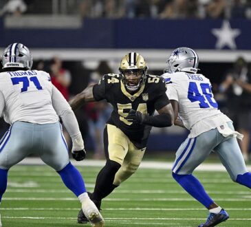 Dallas Cowboys offensive tackle Nate Thomas and tight end Michael Trigg close on New Orleans Saints linebacker Anfernee Jennings.
