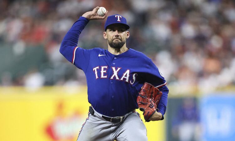 Texas Rangers starting pitcher Nathan Eovaldi rears back to deliver a pitch in a blue road jersey.