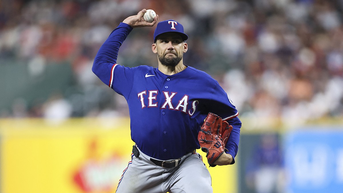 Texas Rangers starting pitcher Nathan Eovaldi rears back to deliver a pitch in a blue road jersey.