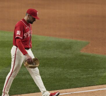 Texas Rangers pitcher Nathan Eovaldi walks off the field with his head down after being pulled against the Orioles.